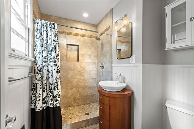 bathroom featuring vanity, toilet, and curtained shower