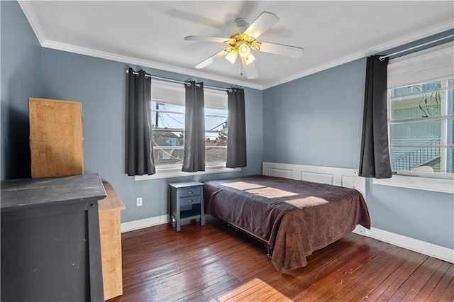 bedroom with crown molding, dark hardwood / wood-style flooring, ceiling fan, and multiple windows