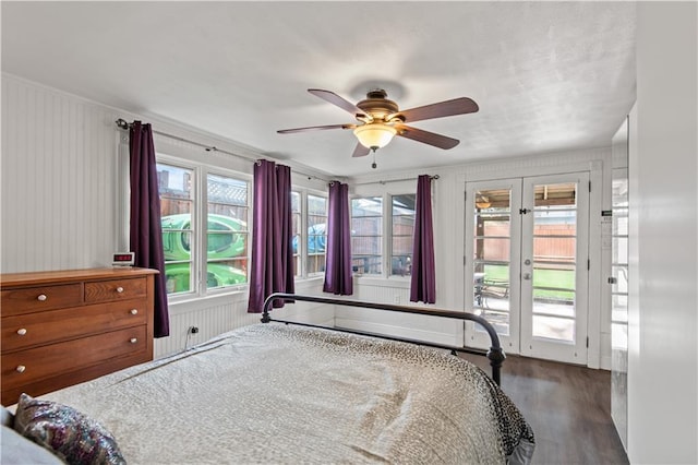 bedroom with ceiling fan, access to exterior, french doors, and dark hardwood / wood-style floors