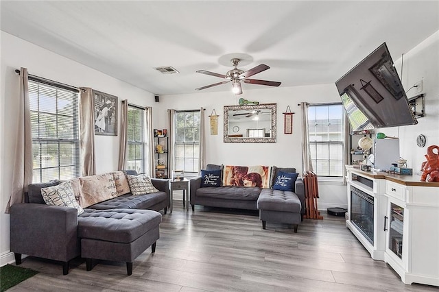 living room with ceiling fan and light hardwood / wood-style floors