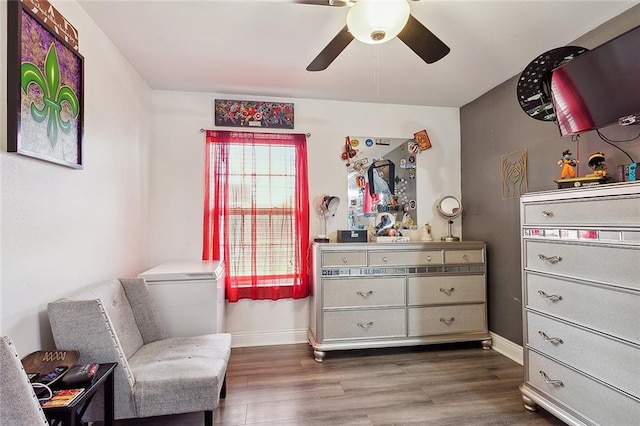 living area with dark hardwood / wood-style floors and ceiling fan