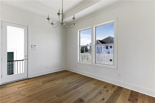 interior space featuring hardwood / wood-style flooring, crown molding, and a notable chandelier