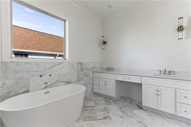 bathroom featuring tile walls, a bathtub, crown molding, and vanity