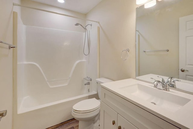 full bathroom featuring shower / washtub combination, wood-type flooring, vanity, and toilet