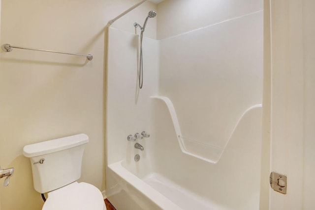 bathroom with shower / bathing tub combination and toilet