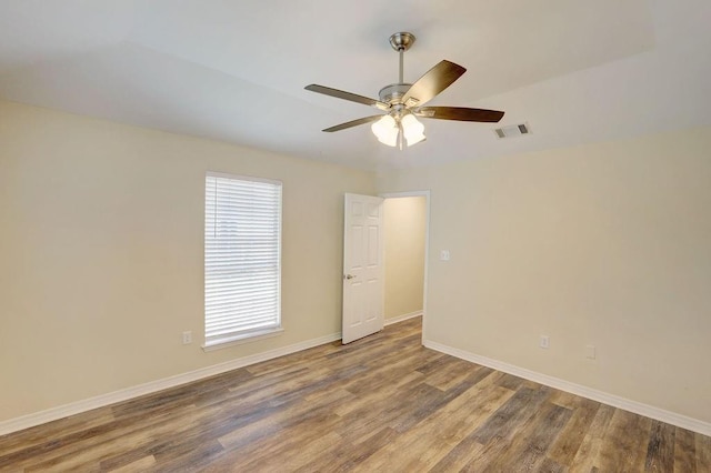 unfurnished room with ceiling fan, hardwood / wood-style flooring, and plenty of natural light