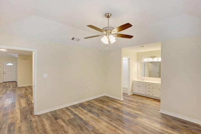 empty room with ceiling fan and wood-type flooring