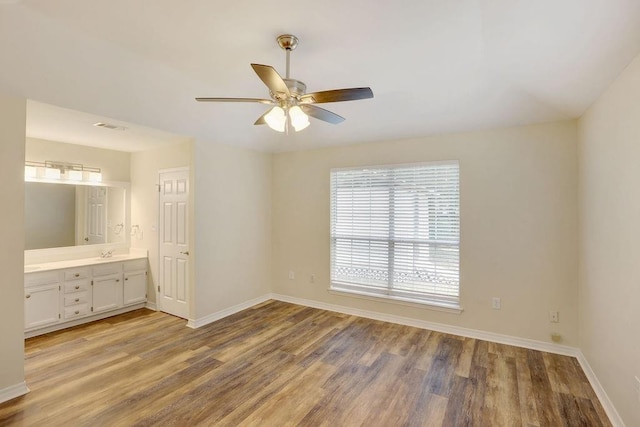 unfurnished bedroom with ceiling fan, sink, light hardwood / wood-style flooring, and ensuite bathroom