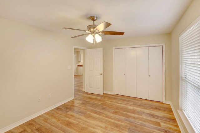 unfurnished bedroom featuring ceiling fan, light hardwood / wood-style flooring, and a closet