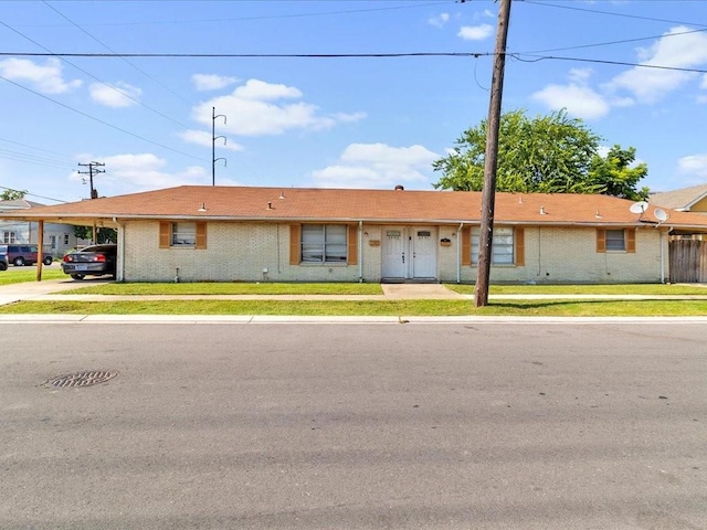 ranch-style home with a front yard and a carport