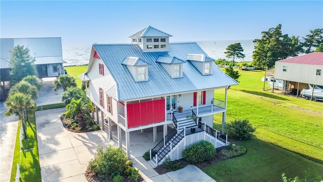 view of front facade featuring a porch, a front yard, and a water view