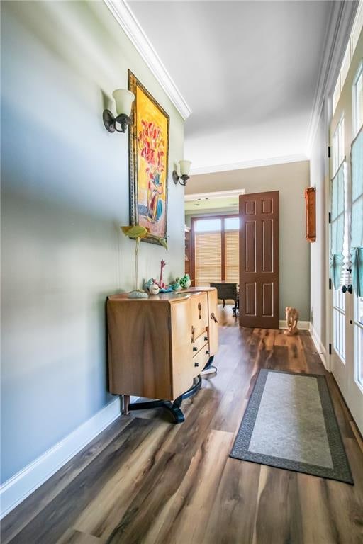 hall with ornamental molding and dark hardwood / wood-style flooring