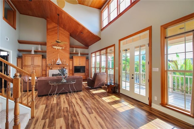 living room featuring hardwood / wood-style floors, high vaulted ceiling, french doors, and wood ceiling