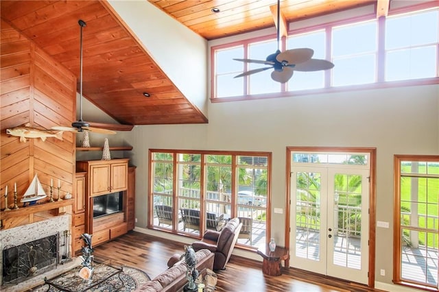 living room with plenty of natural light and wood ceiling