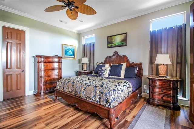 bedroom featuring ceiling fan, wood-type flooring, and crown molding