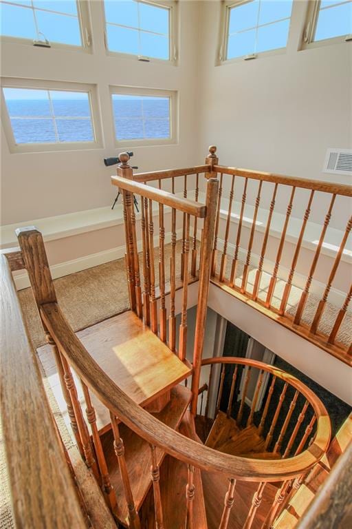 stairs featuring a wealth of natural light and a high ceiling