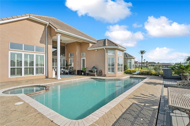 view of pool featuring an in ground hot tub and a patio area