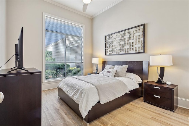 bedroom featuring ceiling fan, light hardwood / wood-style flooring, and ornamental molding