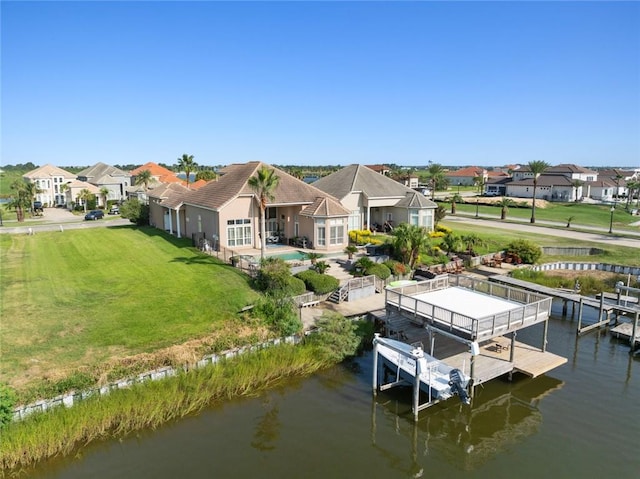 dock area featuring a lawn and a water view