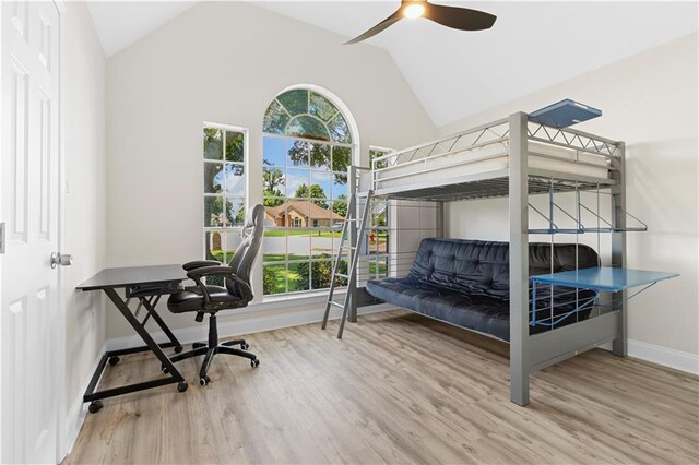 bedroom featuring ceiling fan, high vaulted ceiling, and wood-type flooring