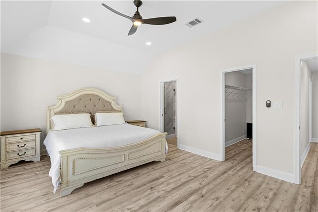 bedroom with ceiling fan, a spacious closet, a closet, and light hardwood / wood-style floors