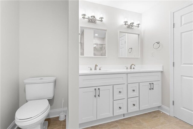 bathroom featuring dual bowl vanity, tile patterned flooring, and toilet