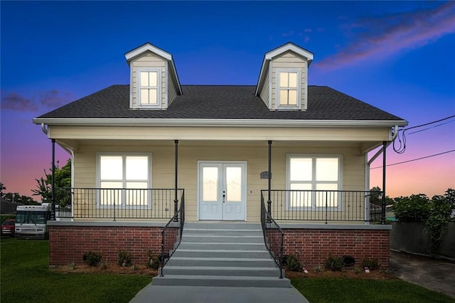 view of front of home with french doors and covered porch