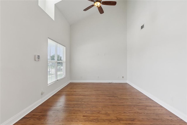 empty room featuring hardwood / wood-style floors, high vaulted ceiling, and ceiling fan