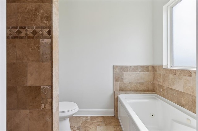 bathroom featuring a bath and toilet