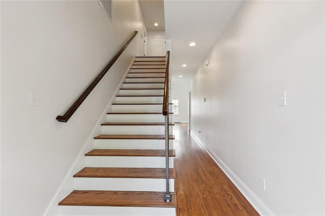 staircase featuring wood-type flooring