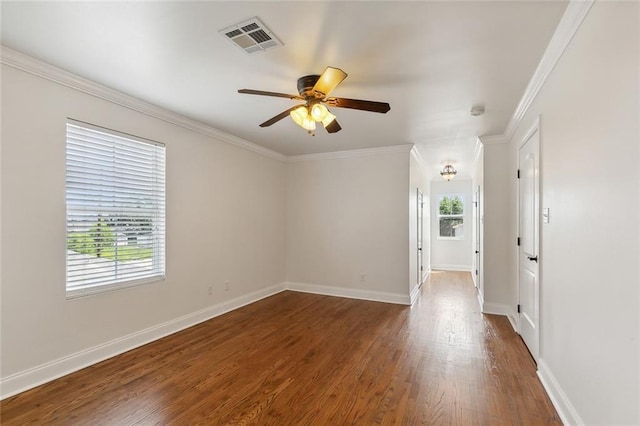 spare room featuring dark hardwood / wood-style flooring, crown molding, and ceiling fan