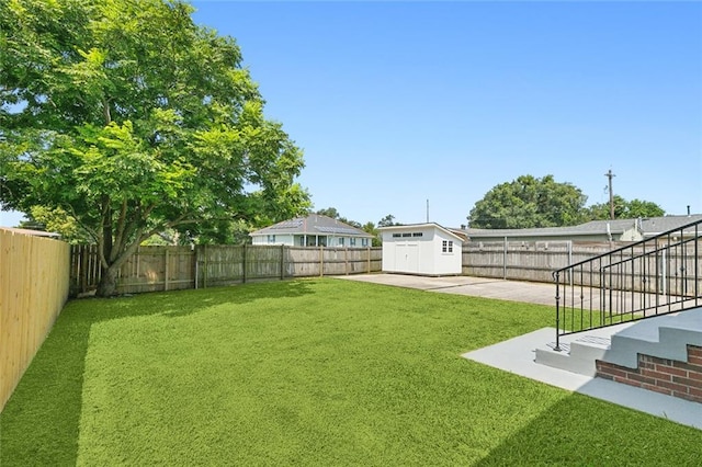 view of yard featuring a storage unit and a patio area