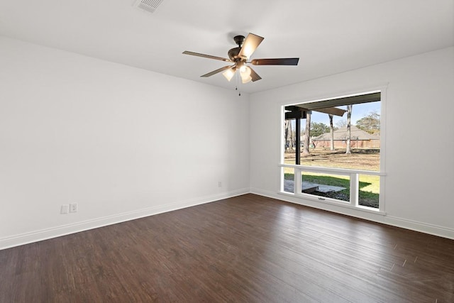 spare room featuring dark hardwood / wood-style floors and ceiling fan