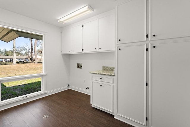 laundry area featuring cabinets, washer hookup, and dark hardwood / wood-style floors