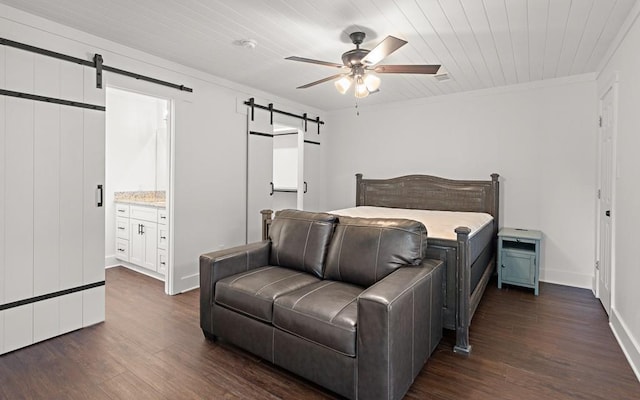 bedroom featuring dark hardwood / wood-style flooring, ensuite bathroom, ceiling fan, a barn door, and wooden ceiling