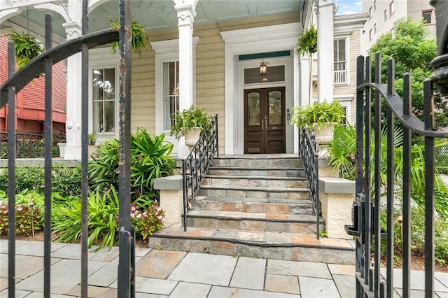 property entrance with a porch and french doors