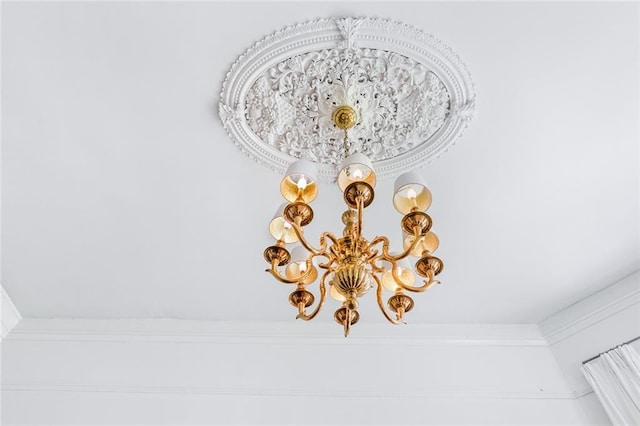 interior details with a notable chandelier and crown molding