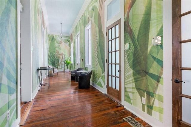 hall with visible vents, wallpapered walls, ornamental molding, hardwood / wood-style flooring, and french doors