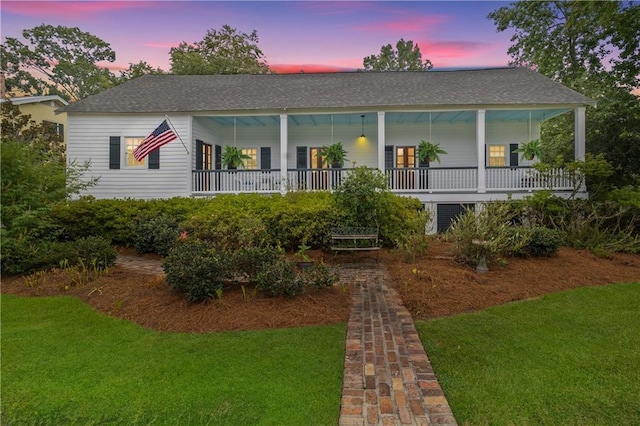 view of front of property featuring a yard and covered porch