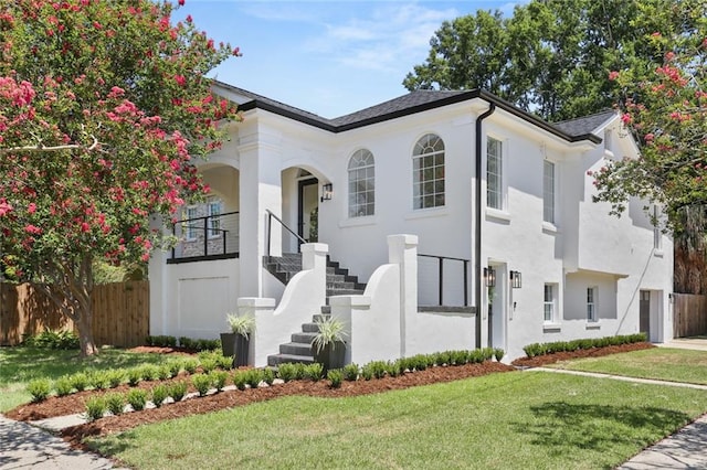 mediterranean / spanish-style house featuring a front yard