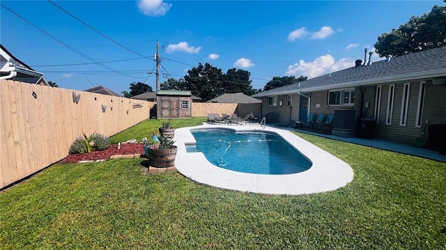 view of swimming pool featuring a patio, a lawn, and a storage unit