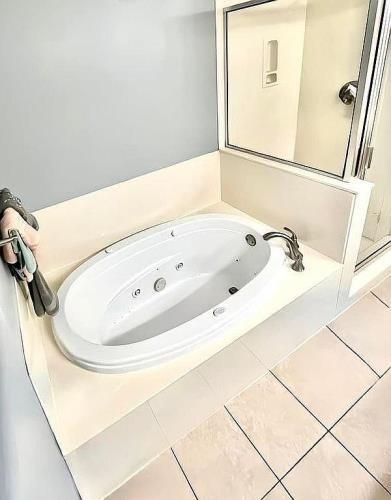 bathroom with independent shower and bath and tile patterned floors