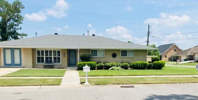 ranch-style home with a front lawn