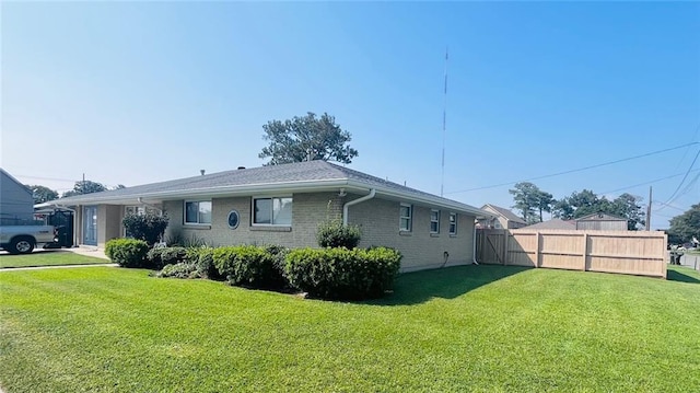 view of side of home featuring a lawn