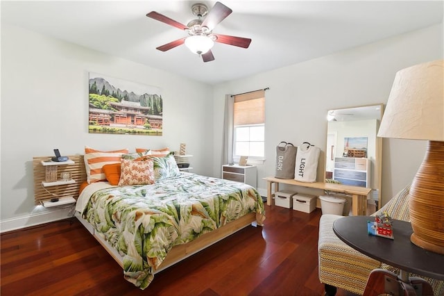 bedroom with dark hardwood / wood-style floors and ceiling fan