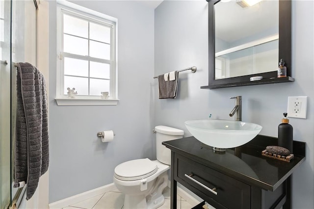 bathroom featuring tile patterned flooring, vanity, and toilet