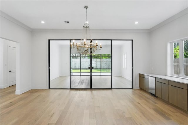 unfurnished dining area featuring light hardwood / wood-style floors and a notable chandelier