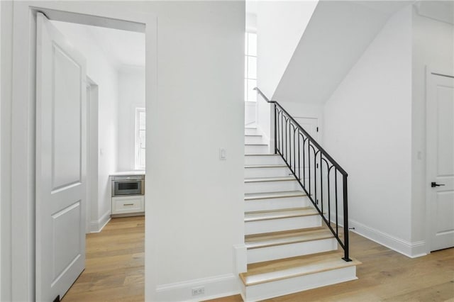 stairs featuring wood-type flooring