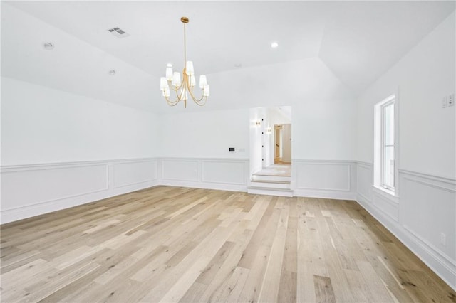 interior space with lofted ceiling, light hardwood / wood-style flooring, and an inviting chandelier