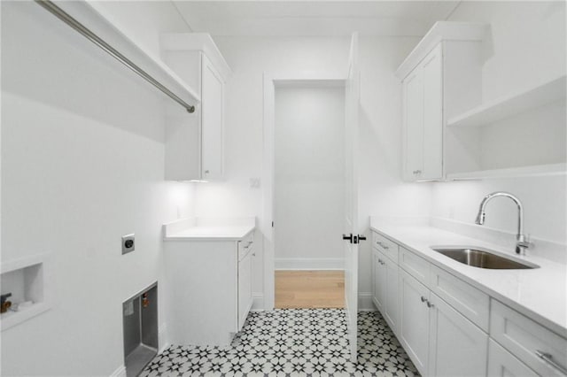 clothes washing area with sink, cabinets, and hookup for an electric dryer